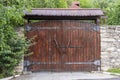 Retro countryside wooden gate with with stone wall in vintage style