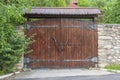 Retro countryside wooden gate with with stone wall in vintage style