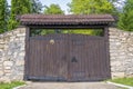 Retro countryside wooden gate with with stone wall in vintage style