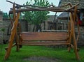 Retro designed old fashioned wooden hammock in backyard