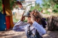 Retro device, soviet stereoscope. Cute girl watching 3D pictures with vintage slide viewer