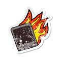 retro distressed sticker of a burning old instant photograph