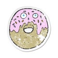 retro distressed sticker of a cartoon doughnut