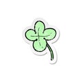 retro distressed sticker of a cartoon four leaf clover