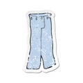 retro distressed sticker of a cartoon pair of jeans Royalty Free Stock Photo