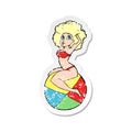 retro distressed sticker of a cartoon pin up girl sitting on ball Royalty Free Stock Photo
