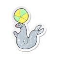 retro distressed sticker of a cartoon seal balancing ball