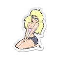 retro distressed sticker of a cartoon woman in skimpy clothing