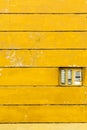 Retro doorbell: electric intercom on te yellow wall texture Royalty Free Stock Photo