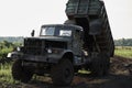 Retro dump truck on a quarry with a raised body