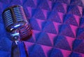 Retro dynamic microphone on a blue studio background Royalty Free Stock Photo