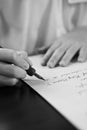 Retro effect faded and toned image of a girl writing a note with a fountain pen antique handwritten letter. Royalty Free Stock Photo