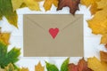 Retro envelope with red heart surrounded by autumn leaves. Template. Backdrop. Mock up Royalty Free Stock Photo