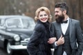 Retro fashion couple. Vintage people at the black retro car. Royalty Free Stock Photo