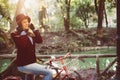 Retro fashion girl riding bike at park on fall day Royalty Free Stock Photo