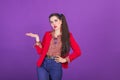 Retro fashion 90s 80s young woman in red jacket portrait, palm up gesture with copy space