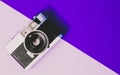 Retro film camera 1970s-1980s on pink purple background