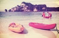 Retro filtered picture of kayaks on a tropical beach.