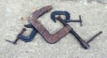 Retro flat closeup of three clamps on concrete on white background. Graphic element. Industry technology concept. Heavy equipment Royalty Free Stock Photo