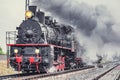 Retro freight train moves under the rain Royalty Free Stock Photo