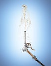 Retro fuel nozzle pump shoots a jet of gasoline up on blue gradient background 3d Royalty Free Stock Photo