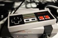 Retro gaming an 8 bit Nintendo Game controller with colourful buttons and Mini NES