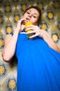 Retro girl in blue dress with orange juice Royalty Free Stock Photo