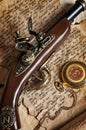 Retro gold pocket watch and antique pistol