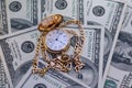 Retro golden pocket watch on Hundred Dollars. Royalty Free Stock Photo