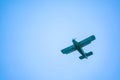 Retro green biplane plane in the blue sky Royalty Free Stock Photo
