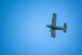 Retro green biplane plane in the blue sky Royalty Free Stock Photo