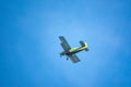 Retro green biplane plane in the blue sky Royalty Free Stock Photo