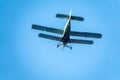 Retro green biplane plane in the blue sky Royalty Free Stock Photo