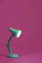 Retro green desk lamp on pink