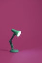 Retro green desk lamp on pink