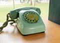 Retro green telephone with garden background Royalty Free Stock Photo