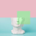 Retro head sculpture against the pastel background and square illustration element.