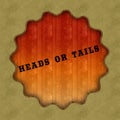 Retro HEADS OR TAILS text on wood panel background.