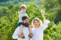 Retro hipster romantic couple in love with happy kid. Freedom to dream - joyful boy playing with toys airplane against