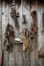 Retro horse harness and other hand tools hanging on wooden wall of old barn Royalty Free Stock Photo