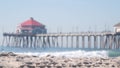 Retro huntington pier, surfing in ocean waves and beach, California coast, USA.