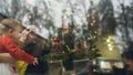 Retro image of a happy young mother holding her baby girl admiring Christmas tree