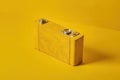 Retro-inspired yellow leather camera on vibrant mono color background Royalty Free Stock Photo