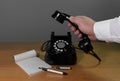 Retro installation. The hand reaches for the phone. Old telephone set on a wooden table, Copy space