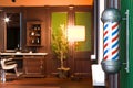 Retro Interior Of Stylish Barber Shop And Vintage Barber Shop Pole.3d Rendering