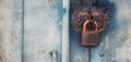 Retro iron lock hanging on the garage door. a locked metallic door with padlock. Copyspace on the left. Security concept Royalty Free Stock Photo