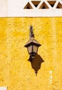 Retro Lamp on the Wall of an Old House in Egypt, Africa. Classic latern. Old Black lantern on Adobe Wall