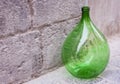 Retro large green glass wine bottle on the sidewalk Royalty Free Stock Photo