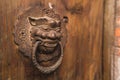 Retro lion head iron door knocker on ancient Chinese wooden door Royalty Free Stock Photo