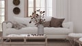 Retro living room in white and bleached wood tones closeup. Sofa, rattan table with autumn decors. Boho chic design, fall interior